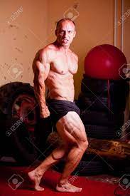 Bodybuilder Fexing His Muscles In A Gym Stock Photo, Picture And Royalty  Free Image. Image 24517397.