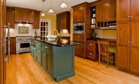 oak cabinets with green island design