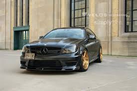 Red accents (decals) on radiator grille and wing mirrors. Matt Black Mercedes C63 Amg On Velos D5 Rims
