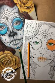 Closeup of chocolate candy skull with bead eyes and colored frosting on white background to celebrate day of the dead. Day Of The Dead Sugar Skull Coloring Pages For Kids