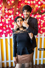 Image of Young Happy Cheerful Indian Couple In Love Have Fun Indoor Against  Floral Background, Boyfriend Girlfriend Relationship, New Year Or  Valentines Day.-TE319521-Picxy