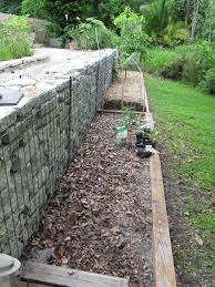 How To Inexpensively Solve Your Sloped Backyard Problems Sloped Backyard Backyard Landscaping Sloped Garden