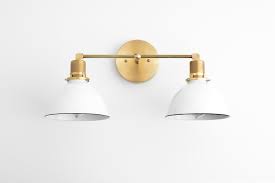 There should be about three inches between the top of the mirror and the bottom of the light fixture. Bathroom Wall Light Industrial Vanity Light Brass Light Fixture White Shade Vanity Fixture Mirror Lighting Model No 9018 Brass Light Fixture White Light Shades White Light Fixture