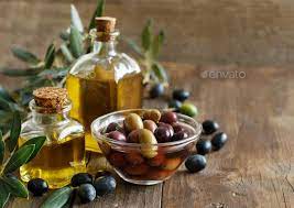 Olive Oil And Olives On Wood Background Extra Virgin Olive Oil Recipes Olive Oil Good For Skin Olive Oil Benefits