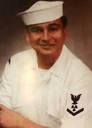 U.S. Navy veteran Dale Franks salutes the American Flag at the Memorial  High School Veterans Day tribute. He is a member of the Ely Honor Guard.