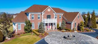 A red brick house with stone accents. What Color Roof Goes With Red Brick Shingle Colors