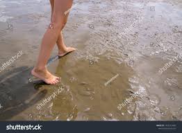 girl runs through mud flats sinks stock