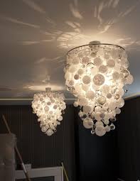 The light's angular shade is crafted using cast concrete to showcase the material in all its coral chandelier. Opus Collection Roast Designs Bespoke Contemporary Chandeliers