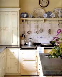 Exposed brick walls painted white lighten the room and a large island invites gathering. 15 Best English Country Kitchen Decor Ideas