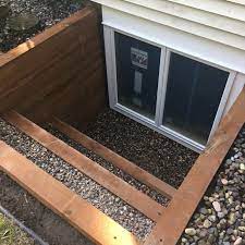 Not all basement windows are egress windows. Anderson Double Casement In A Terraced Timber Well Great Looking Addition To Customers Home In Ed Basement Windows Basement Window Well Waterproofing Basement
