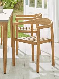 The most common dining arm chairs material is wood. Two Acacia Dining Chairs