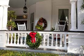 This shabby chic christmas porch decoration idea makes use of antique finds such as an old ceramic crock, rusty gardening tools, an enamel bowl, a galvanized watering can and several other rustic pieces to create a playful display. Christmas Porch Decorations