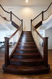 Grouped spindle curved stairs | open riser. Contemporary Flared Staircase Specialized Stair Rail