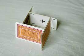 A house of cards is a structure created by stacking playing cards on top of each other. How To Build A House Of Cards House Of Cards Building A House Deck Of Cards