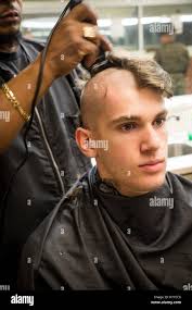 U.S. Marine Corps Rct. Mitchell Sanchez, Echo Company, 2nd Recruit Training  Battalion, receives his first recruit training haircut Jan. 8, 2018,