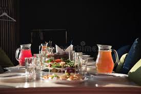 When every guest has finished and laid his spoon, bowl up, across the upper right hand corner of the plate, the plate, bowl, and spoon will be removed. Table Setting For A Party Or Banquet In A Cozy Small Room There Are Dishes And Drinks On The Table And Sofas With Pillows Are Stock Image Image Of Childrens Birthday