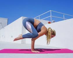 How To Do Crow Pose With A Block Well Good Crow Pose Arm Balance Yoga Poses Yoga Block
