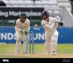 Derbyshire's Wayne Madsen batting and watched by Leicestershire keeper  Harry Swindells during a County Championship match Stock Photo