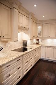 White Kitchen Design Giallo Ornamental Granite Countertops White Cabinets Dark Wood Floor Granite Countertops Kitchen White Kitchen Design Kitchen Inspirations