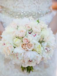Beautiful white wedding cake with floral decor displayed on a wooden slice. 20 Romantic White Wedding Bouquet Ideas