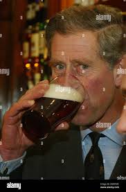 Prince Charles samples a pint of beer ...