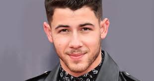 How Nick Jonas' Groomer Styles His Curls And Mustache