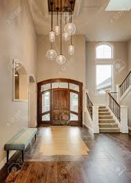Gorgeous vaulted ceilings provide a sense of luxury and open the home to sun, while exposed beams have a warming effect on the room as a whole. Beautiful Foyer In Home Entryway With Stairs Pendant Lights Stock Photo Picture And Royalty Free Image Image 50555921