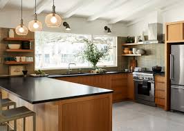 Black industrial island lights illuminate modern kitchen that features a light blue. 75 Beautiful Kitchen With Brown Cabinets And Black Countertops Pictures Ideas July 2021 Houzz