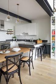 Lovely Kitchen Features Black Ceiling Beams Over White Shaker Cabinets Paired With Black Quartz Quartz Kitchen Countertops Best Kitchen Countertops