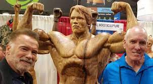 Bodybuilders stand next to the trophy during of the 5th wbpf world championships in budaors, hungary on november 17, 2013. James O Neal The Man Behind Arnold And Franco S Wooden Statues