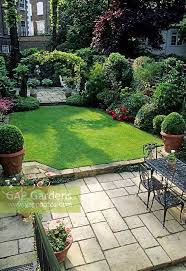 Small Formal Town Garden With Paved Patio Dining Table And Chairs Lawn Containers Borders And Arch Small Patio Garden Patio Landscaping Small Garden Design