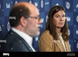 Vancouver Whitecaps general manager of women's soccer Stephanie Labbe, back  right, former Canadian women's national soccer team goalkeeper, listens as  Whitecaps CEO Axel Schuster speaks during a news conference after she was