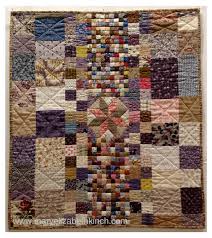 The log cabin pattern features a variety of feedsack fabrics clustered to create light and dark patterns and the backing fabric is a floral print. What To Do With Old Quilts 5 Ideas To Ponder Stitch This The Martingale Blog