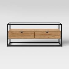 This round coffee table features a caged iron frame with a removable wood top that can hold snacks and drinks when you're hosting guests, as well as doubling as storage for extra pillows, blankets and more. Ada Mixed Material Coffee Table With Glass Top Project 62 Target
