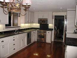 White laminate countertop with valencia edge in typhoon ice with integrated backsplash. Friday Afternoon White Cabinets Black Kitchen Countertops Kitchen Cabinets And Countertops Kitchen Design