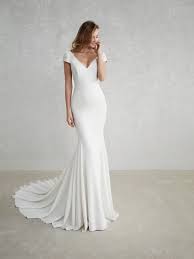Removable ribbon with flower detail defines the natural waist. 21 Exquisite Wedding Dresses With Cap Sleeves Weddingsonline