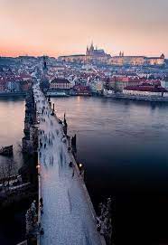 The Czech Republic Prague Medieval Magic Tourists Scurry Across The Charles Bridge Over The Vltava River To Places To Travel Places To Go Places To Visit