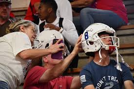 Dog Tag 2024. Varsity football members and their families met tonight to  place numbers and decals