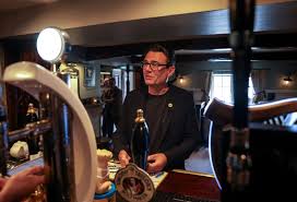 Britain's new prime minister hands pubs business rates cut | Reuters