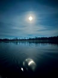 Sunset and super blue moon over water