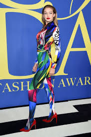 Make your look fierce by aiming for a khaki or muted green jumpsuit with heeled boots and aviators. Gigi Hadid Wears Rainbow Jumpsuit At Cfda Fashion Awards Gigi S 2018 Cfda Awards Look