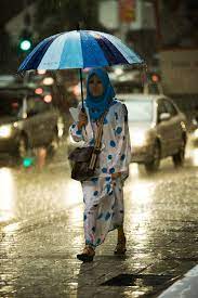 A Muslim Woman Remains Dry During A Typical Malaysian Downpour In Kuala Lumpur Malaysia Walking In The Rain I Love Rain Rainy Weather
