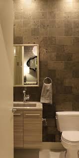 The powder room is the bathroom where you can experiment, be bold, go dark and moody, do some fun wallpaper, a fabulous vessel sink, get a little crazy if you want. Modern Powder Room With Stone Tile Backsplash Floating Vanity And Modern Fixtures Hgtv