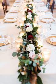 It features blooms that have a light green tint along with wavy, long green leaves, all arranged within a contemporary white vase filled with natural green moss. 52 Wedding Long Tables And Receptions Ideas Weddingomania