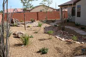 Used desert sunrise grey colored 1 1/2 inch cobble rock with fabric underlayment. Desert Landscape By The Yard Dr St George Utah S Premier Landscaper Commercial Landscaping Landscape Desert Landscaping