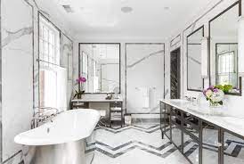 The wide black bathroom tiles with an exceptionally glossy surface contrast the bright white vanity that creates the dramatic contrast in the art deco interior. Art Deco Bathroom Interior Design