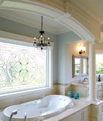 A traditional chandelier hangs above the tub in this rustic bathroom accented with a wooden window frame and side table. 80 Primary Bathrooms With Chandelier Lighting Photos Home Stratosphere