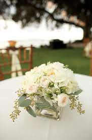 Square Glass Vase With White Hydrangea Roses And Seeded Eucalyptus White Flower Centerpieces Flower Centerpieces Wedding Wedding Flowers Hydrangea