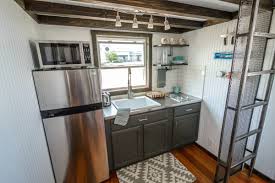 An incredibly popular #tinyhouse living storage idea is to use the space under. Tiny House Kitchen Design Tiny Home Builders