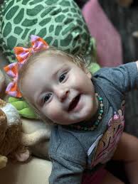 Adorable girl in romper and bling tights outfit